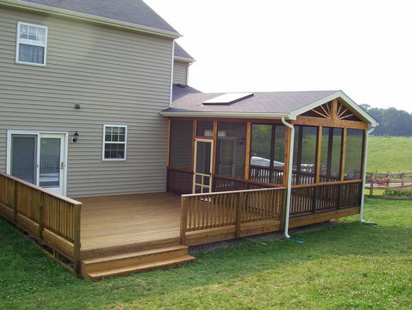 Large wooden deck with screened porch